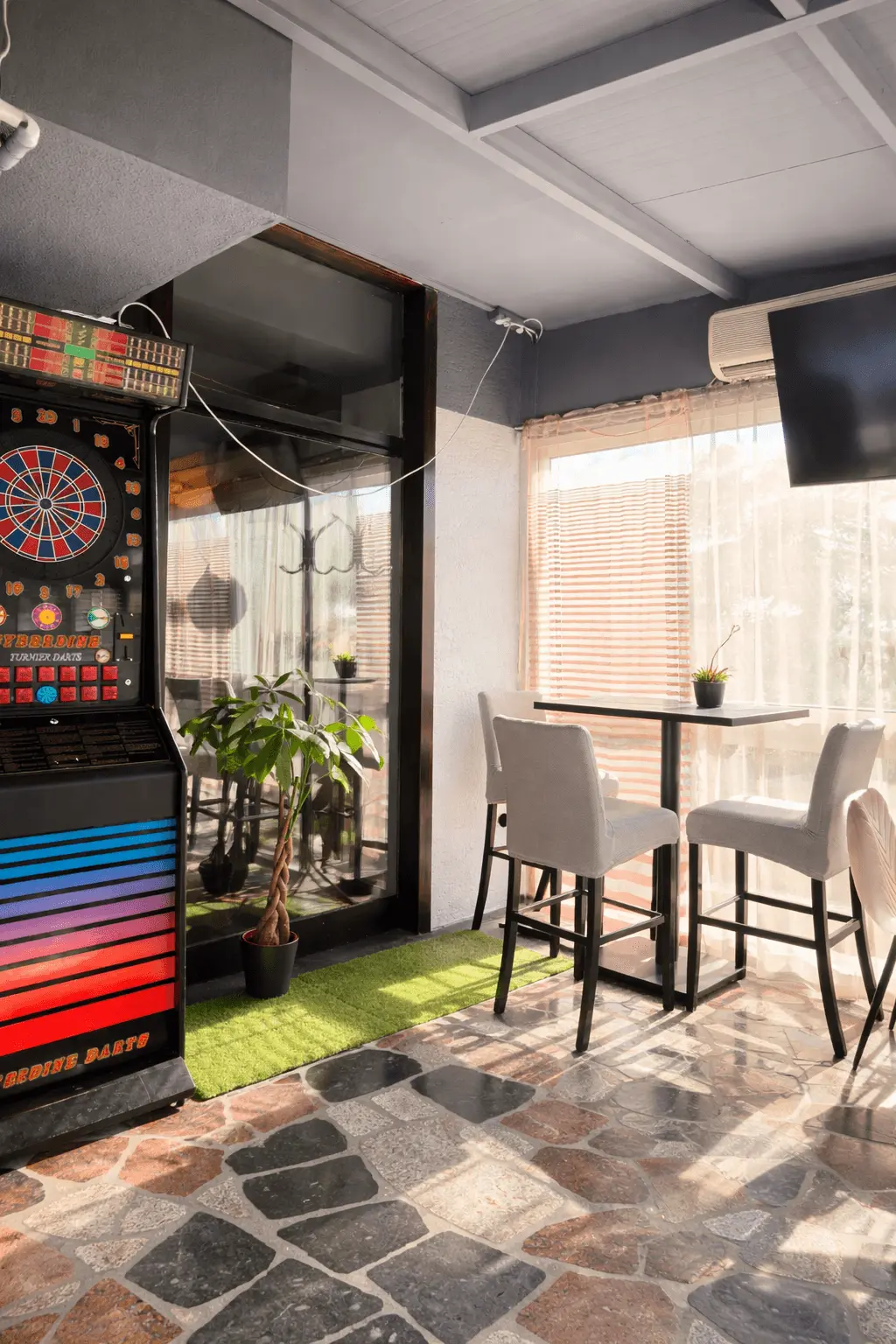 Modern bar with dartboard and plants